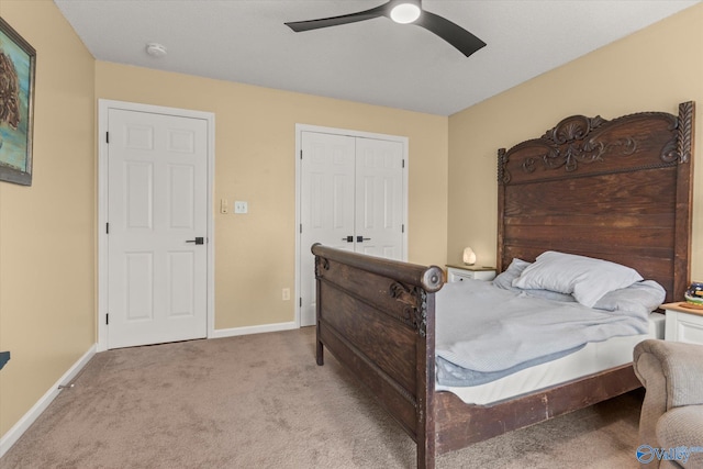 bedroom featuring light carpet, a closet, and ceiling fan