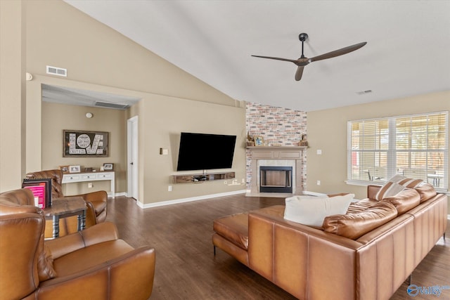 living room with ceiling fan, high vaulted ceiling, a large fireplace, and dark hardwood / wood-style floors