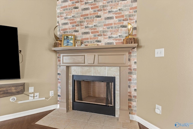 room details featuring a tile fireplace and tile patterned flooring