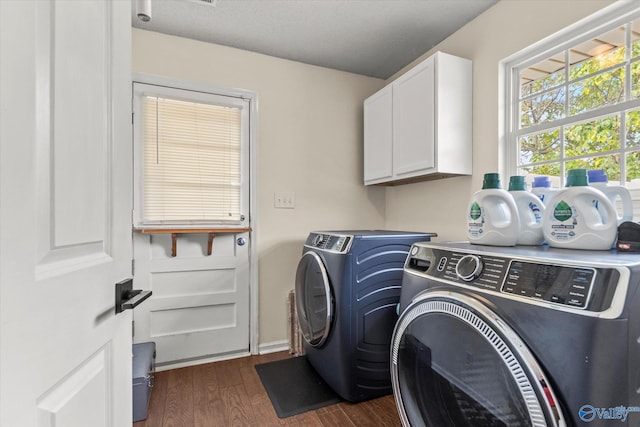 laundry area featuring dark wood-type flooring, independent washer and dryer, and cabinets