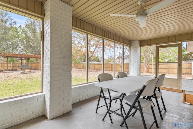 sunroom featuring ceiling fan and a wealth of natural light