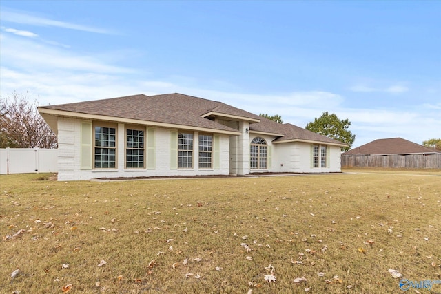 back of house featuring a patio and a lawn