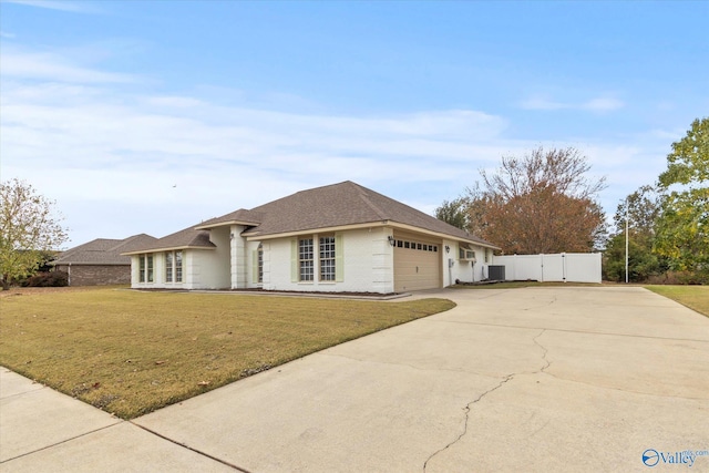 ranch-style house with a front yard and a garage