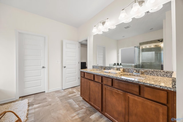 bathroom with vanity and a shower with door