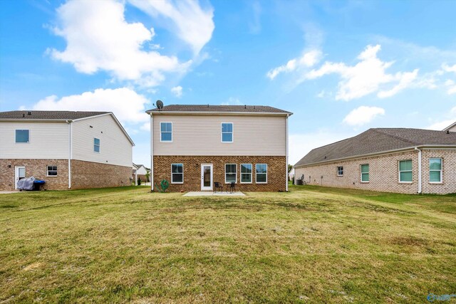 rear view of house featuring a yard