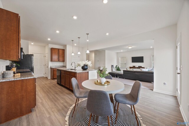 dining area with light hardwood / wood-style flooring and sink