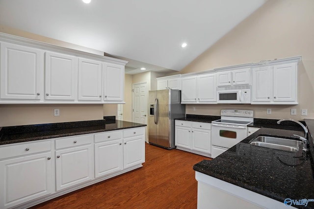 kitchen with white cabinetry, lofted ceiling, sink, and white appliances