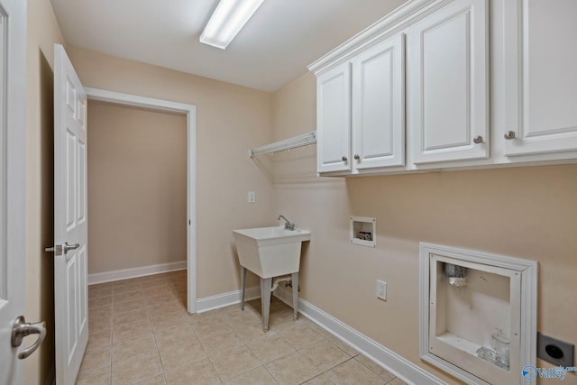 laundry area with light tile patterned flooring, cabinets, hookup for an electric dryer, and hookup for a washing machine