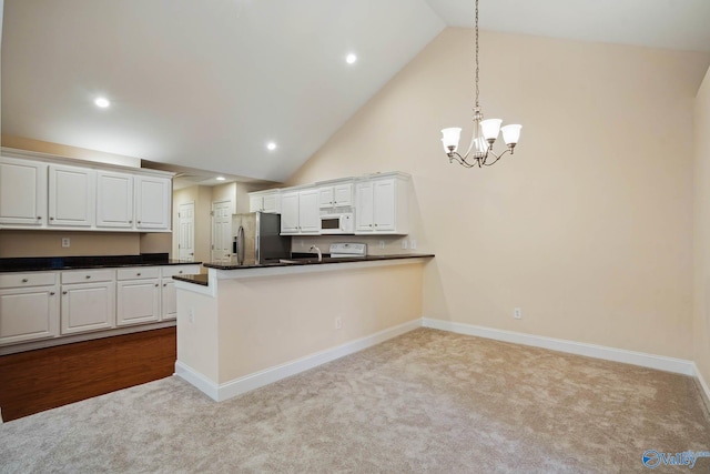 kitchen with pendant lighting, kitchen peninsula, white cabinets, and stainless steel refrigerator with ice dispenser