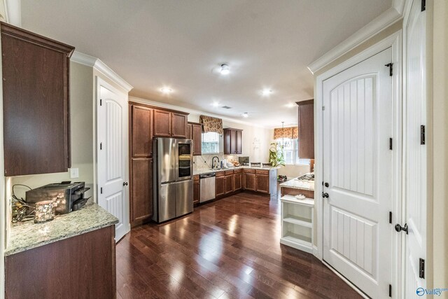 1117 Pegasus Dr NW, Huntsville, AL 35806 - kitchen with stainless steel appliances, dark wood-style floors, light stone counters, crown molding, and recessed lighting