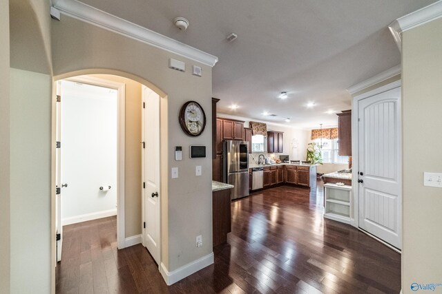 1117 Pegasus Dr NW, Huntsville, AL 35806 - kitchen with stainless steel appliances, ornamental molding, arched walkways, dark wood-style floors, and recessed lighting