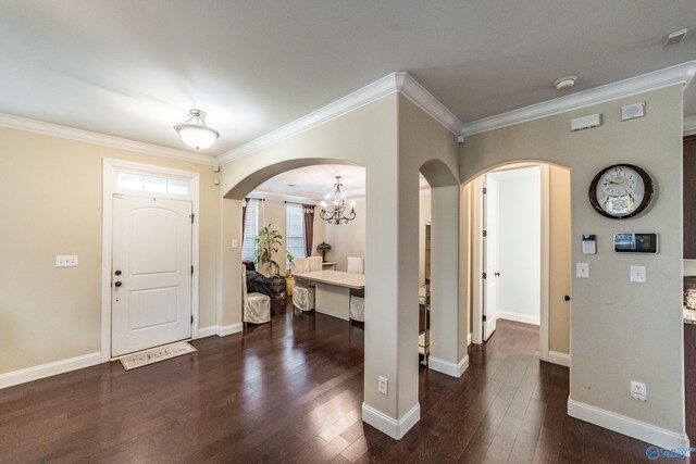 1117 Pegasus Dr NW, Huntsville, AL 35806 - foyer entrance with crown molding, dark wood-style flooring, arched walkways, and a chandelier