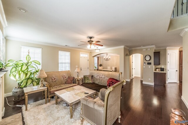 1117 Pegasus Dr NW, Huntsville, AL 35806 - living room featuring arched walkways, a ceiling fan, dark wood-style floors, ornamental molding, and a chandelier
