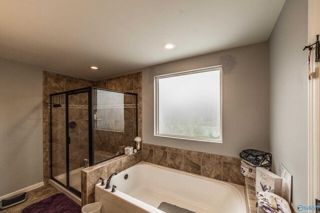 1117 Pegasus Dr NW, Huntsville, AL 35806 - bathroom with a garden tub, a stall shower, recessed lighting, and tile patterned floors