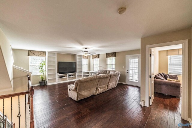 1117 Pegasus Dr NW, Huntsville, AL 35806 - living area with arched walkways, a ceiling fan, dark wood-style flooring, crown molding, and a chandelier