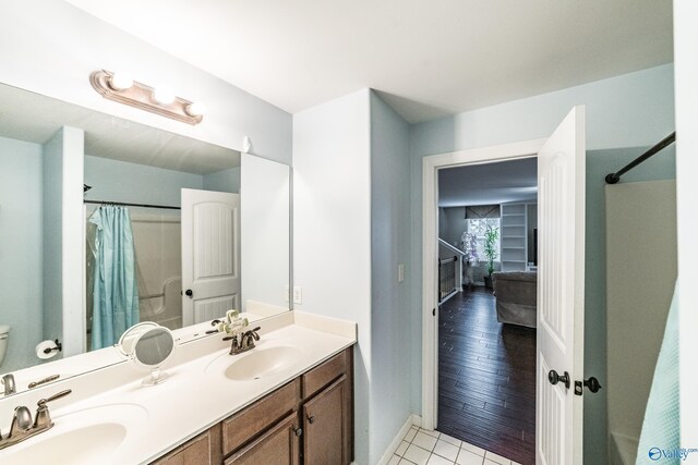 1117 Pegasus Dr NW, Huntsville, AL 35806 - full bathroom with double vanity, curtained shower, and tile patterned floors