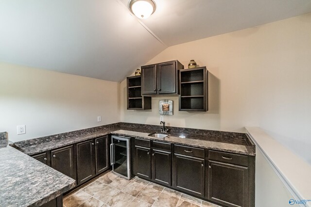 1117 Pegasus Dr NW, Huntsville, AL 35806 - kitchen featuring beverage cooler, open shelves, vaulted ceiling, dark cabinetry, and dark stone counters