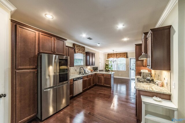 1117 Pegasus Dr NW, Huntsville, AL 35806 - kitchen with appliances with stainless steel finishes, a peninsula, dark wood-style flooring, light stone countertops, and recessed lighting
