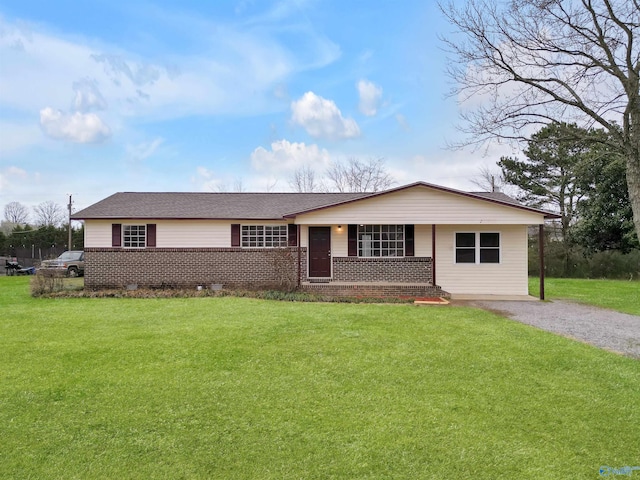 ranch-style home with crawl space, brick siding, roof with shingles, and a front yard