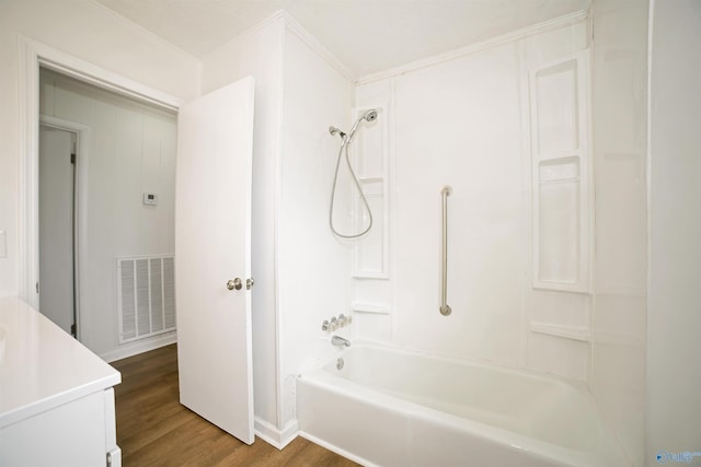 full bathroom featuring visible vents, shower / bath combination, and wood finished floors