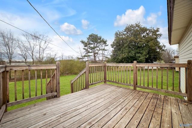 wooden terrace featuring a yard