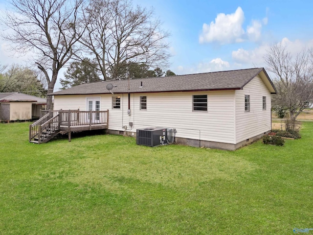 rear view of property with central air condition unit, a deck, a yard, a shingled roof, and crawl space