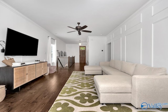 living room featuring crown molding, dark hardwood / wood-style floors, and ceiling fan