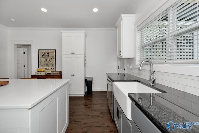 kitchen with crown molding, decorative backsplash, and white cabinets