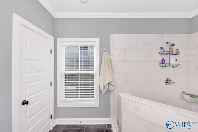 bathroom with ornamental molding and a tile shower