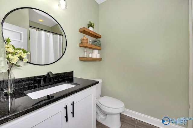 bathroom featuring vanity and toilet