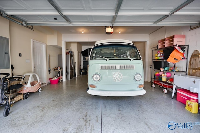 garage with stainless steel refrigerator and a garage door opener