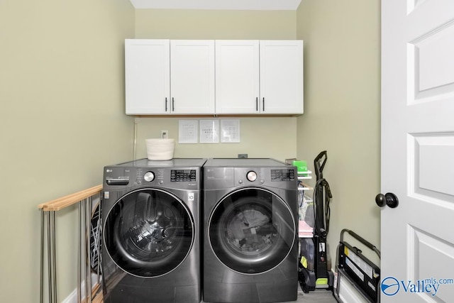 laundry area with cabinets and washing machine and clothes dryer