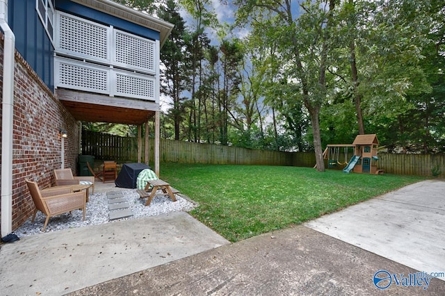 view of yard featuring a playground and a patio area