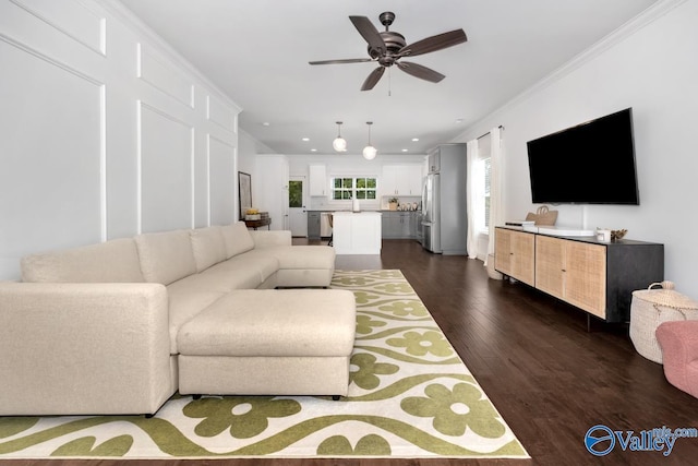 living room featuring crown molding, ceiling fan, dark hardwood / wood-style floors, and sink