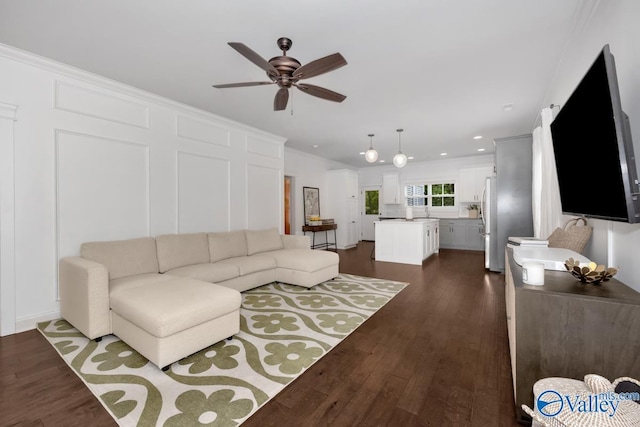 living room featuring ornamental molding, dark hardwood / wood-style floors, and ceiling fan