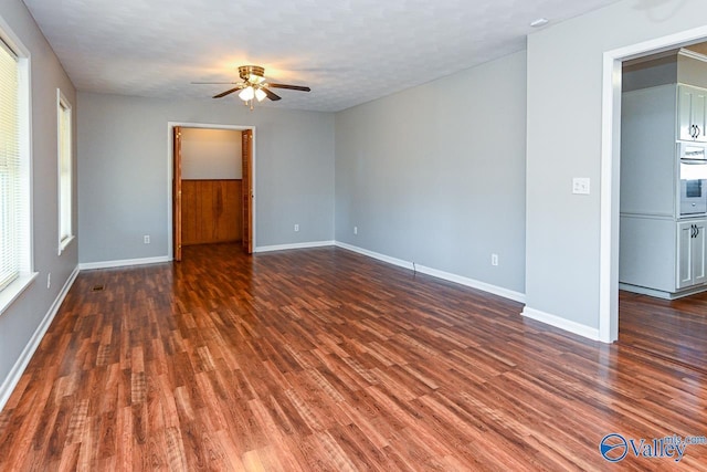 7853 Danville Rd, Danville, AL 35619 - spare room with ceiling fan, dark wood-type flooring, and baseboards