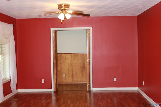 unfurnished room with ceiling fan, baseboards, and wood finished floors