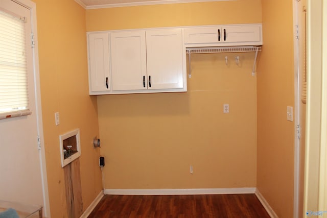 clothes washing area featuring cabinet space, baseboards, dark wood finished floors, ornamental molding, and hookup for a washing machine