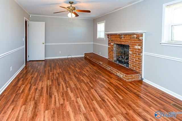 7853 Danville Rd, Danville, AL 35619 - unfurnished living room featuring a ceiling fan, ornamental molding, wood finished floors, a fireplace, and baseboards
