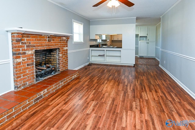 7853 Danville Rd, Danville, AL 35619 - unfurnished living room with wood finished floors, ornamental molding, ceiling fan, a fireplace, and baseboards