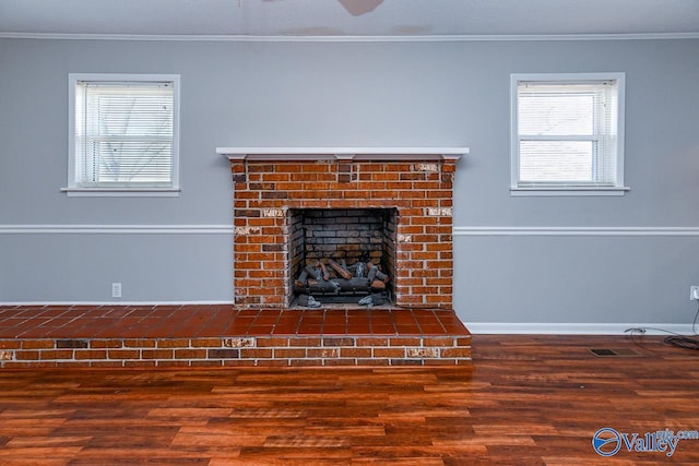 7853 Danville Rd, Danville, AL 35619 - detailed view of wood finished floors, ornamental molding, a brick fireplace, and baseboards