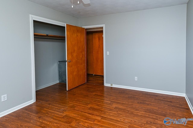 7853 Danville Rd, Danville, AL 35619 - unfurnished bedroom with wood finished floors, baseboards, a closet, and a ceiling fan