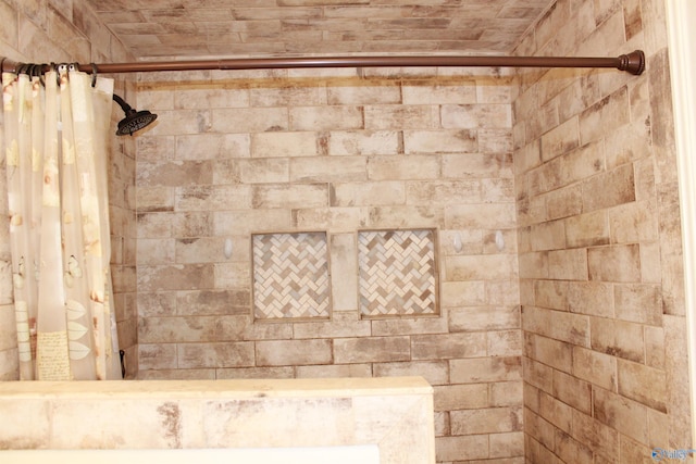 full bath with a tile shower