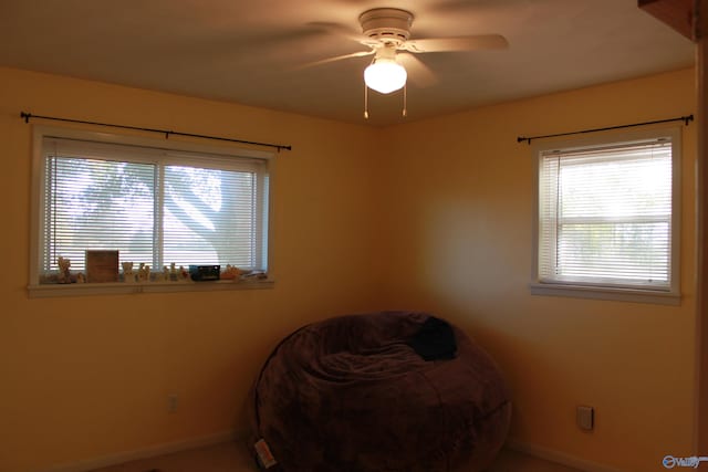 unfurnished bedroom with a ceiling fan and baseboards