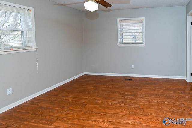 7853 Danville Rd, Danville, AL 35619 - unfurnished room with ceiling fan, baseboards, and wood finished floors