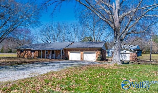 7853 Danville Rd, Danville, AL 35619 - single story home with covered porch, asphalt driveway, an attached garage, and a front lawn