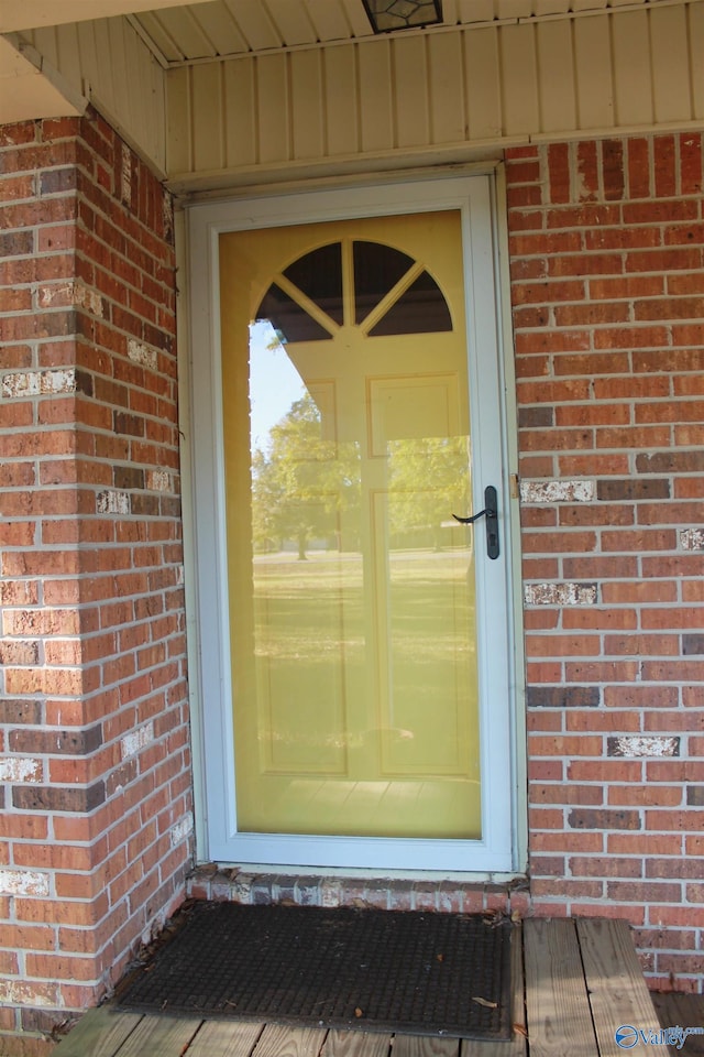 entrance to property with brick siding