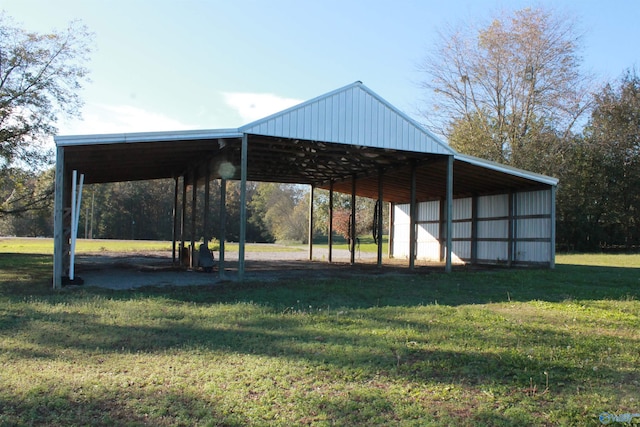 surrounding community featuring a pole building, a lawn, and an outdoor structure