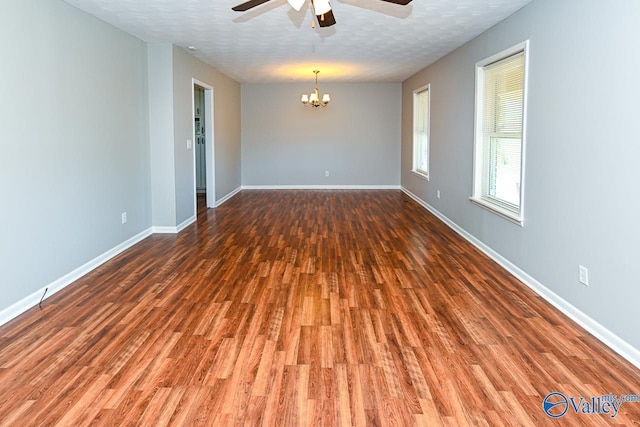 7853 Danville Rd, Danville, AL 35619 - unfurnished room with ceiling fan, wood finished floors, a chandelier, and baseboards