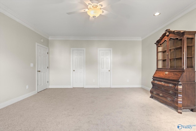 unfurnished bedroom with ceiling fan, crown molding, and light carpet